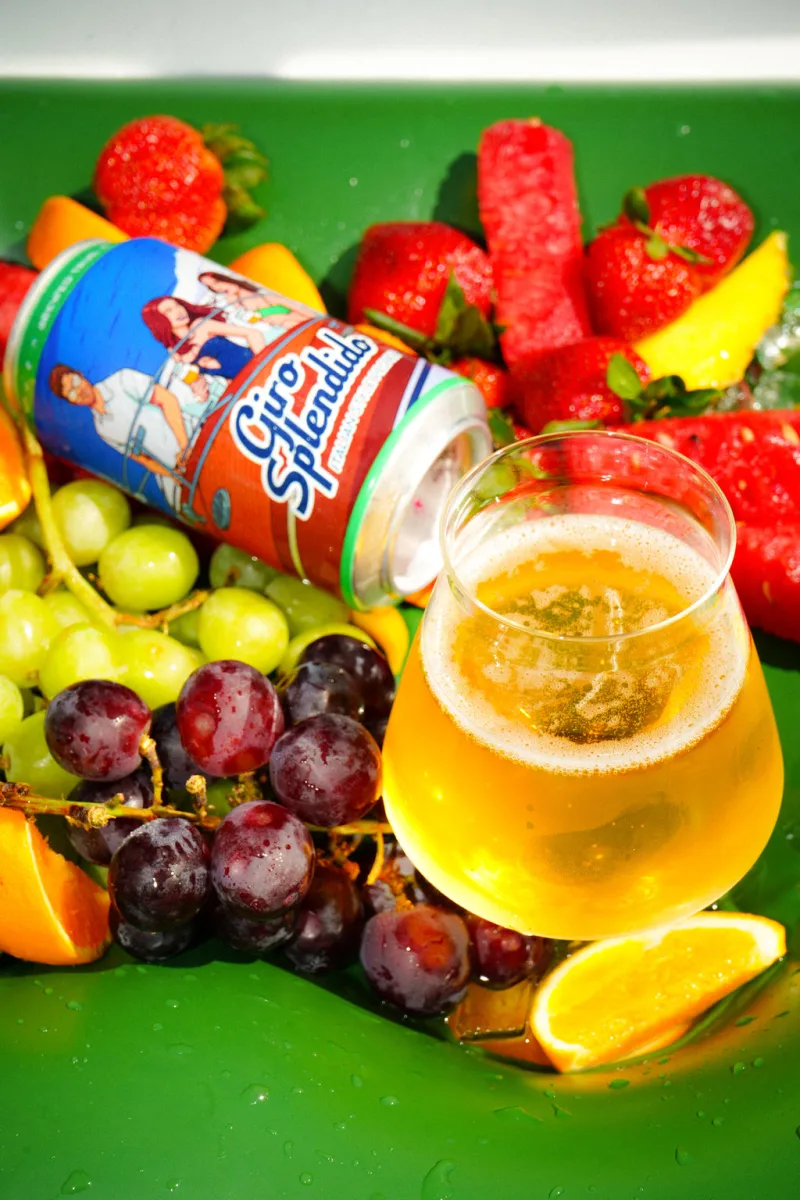 A Giro Splendido can and glass among summer fruit