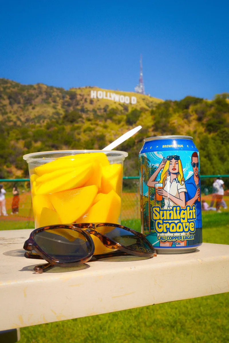 A cooler of cans under an open sky