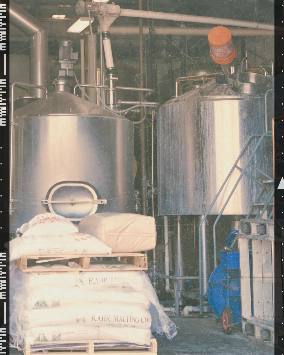 Brew kettles and sacks of grain inside the brewhouse